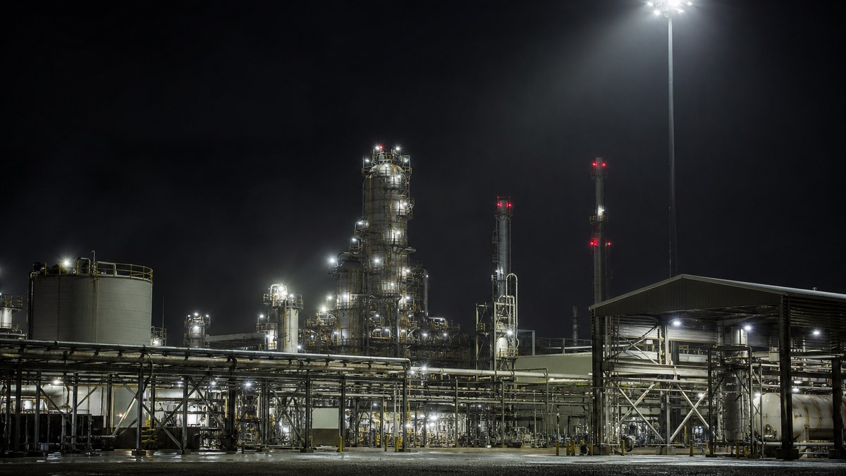 Gulf Coast industrial facility near Houston at night lit by corrosion-resistant LED area and high-mast lighting