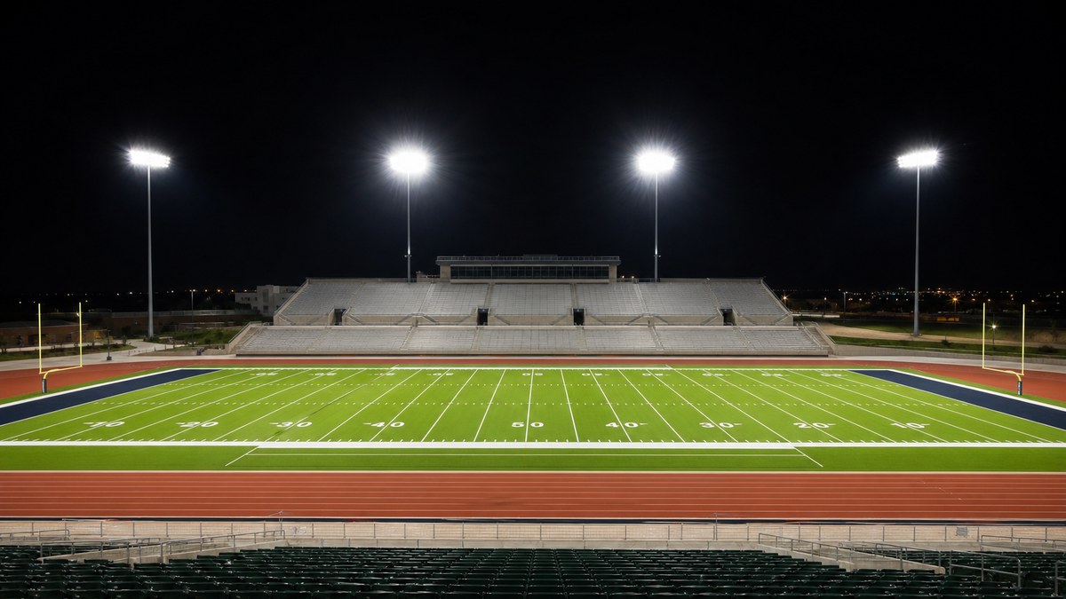 Texas football stadium lit by LED sports field lighting at night